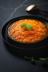 Pumpkin soup on black background