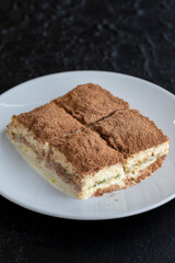 Cold baklava on a dark background. Turkish sweet dessert concept. plate of sliced forest fruit cake. Plate of cold milk baklava. Mediterranean bakery. close up. selective focus. soguk baklava
