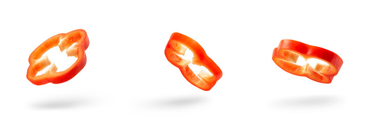 Set of slices of red pepper drops on a white background. Paprika flying in air on isolated white...
