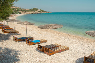 One empty chair on white sandy beach near the sea in summer