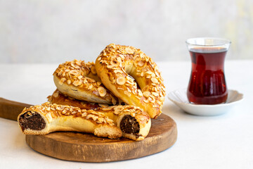 Turkish Ay coregi and tea. moon cookie on white background. Croissant with chocolate cocoa and raisin. Close up. Selective focus. Horizontal view