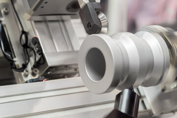 Automated cnc turning milling machine cutting metal workpiece at factory, exhibition, plant. Metalworking, engraving, industrial, equipment, technology, manufacturing concept