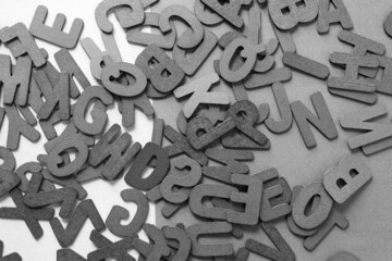 black and white letters scattered on a surface