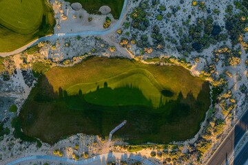 aerial view golf club surrounded by wetland. sport green landscape, hotel and real estate industry Gulf of California desert.
