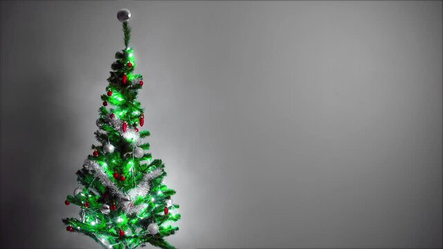 New year celebration design. A design video where you can use text, logo, visuals next to the sparkling image of the pine tree. The pine lights are flashing.