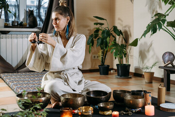 Sound healing with singing bowls, vibration massage and alternative therapy. Mental health care in...