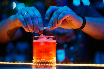 the bartender prepares a cocktail in the night bar
