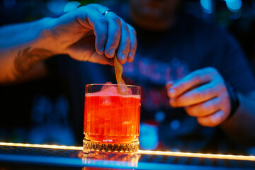 the bartender prepares a cocktail in the night bar