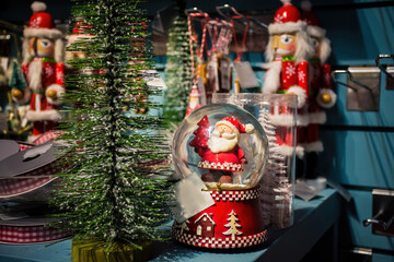 Father Christmas-Santa Claus. Christmas decorations on sale in a garden centre, near Lacock, England