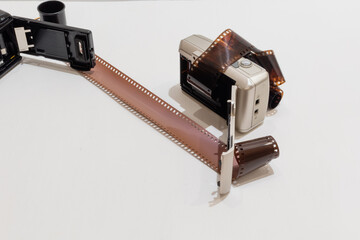 Film cameras of simplest design with films for amateur photography on white background