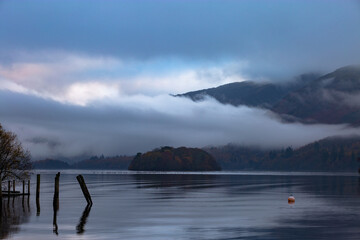 dramatic cloud inversion over tranquil lake with island and reflections. Derwentwater, England
