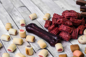 Dog tasty colored biscuits on wooden background
