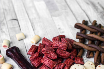 Dog tasty colored biscuits on wooden background