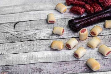 Dog tasty colored biscuits on wooden background
