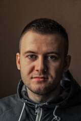 close-up portrait of a young man on a gray background