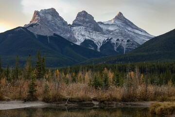 Three Sisters mountains, taking guards over Canmore in Alberta, Canada