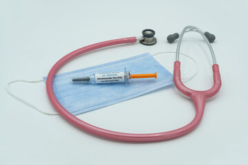 Covid 19 syringe on mask with stethoscope. Healthcare and medical concept . Omicron.