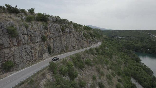 aerial drone following a car in national park Krk Krka in Croatia in beautiful nature countryside
