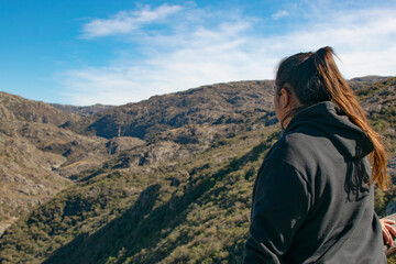 young woman trekking taking mates and looking at the mountain