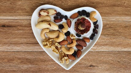 Dried fruits on wooden background. Space for text.