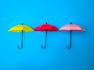Colorful miniature umbrella on a blue background