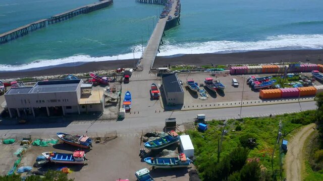 port or caleta meguellines, constitucion chile drone shot sunny day with fishing boats drone reveal shot
