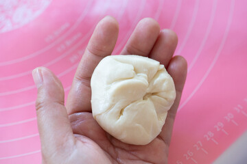 Closed up photo of dough on woman hands.
