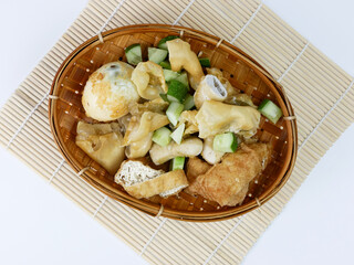 batagor or fried dumplings on a bamboo plate