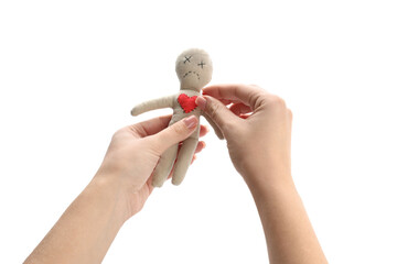 Woman stabbing voodoo doll with pin on white background, closeup