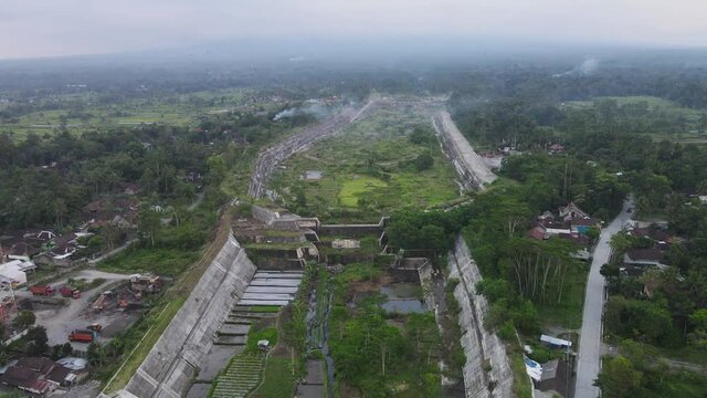 Aerial video of the sabo dam holding back the cold lava of Mount Merapi on the Gendol river, Yogyakarta, Indonesia.