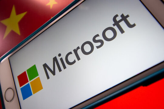 Kumamoto, JAPAN - Mar 10 2021 : Concept Image Microsoft Logo On IPhone With Chinese Flag Background. Cyberattack, IT Technology Risk And Conflict Concept