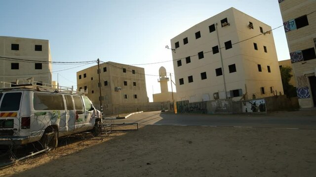 terrorist car van with palestine grafitty on it in a square of a palestine city in desert landscape