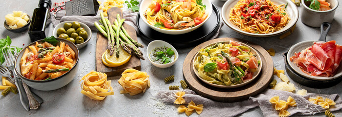 Pasta assortment on gray background.