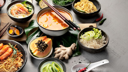 Asian dishes variety on gray background.