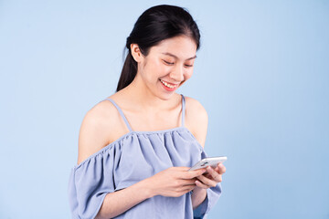 beautiful young asian girl portrait, isolated on blue background