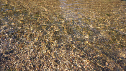 Sand surface in clear water taken from a stream near the garden.