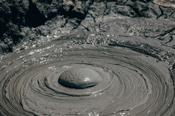 Fototapeta na wymiar Mud volcanoes at Gobustan, Azerbaijan. Landmark area filled with hills made from mud where eruptions are seen. Detail of a mud bubble.