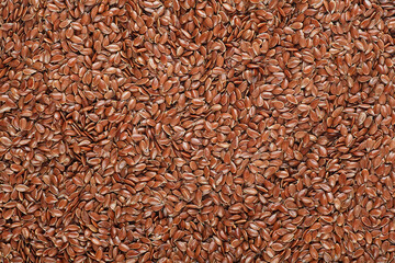 Brown flax seeds as a background, top view. 