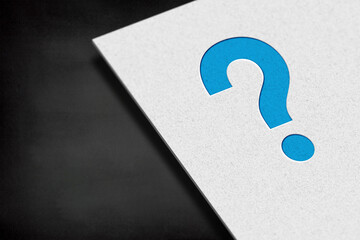 Question mark with white paper on black background