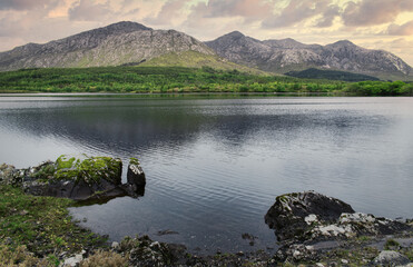 Beautiful cloudy landscape scenery with mountains reflected in lough inagh at Connemara National park in county Galway, Ireland 