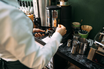 Close up of barista hands preparing coffee for customer in coffee shop