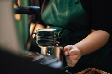 Fototapeta na wymiar Close up of barista hands preparing coffee for customer in coffee shop
