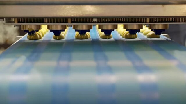 Moving confectionery along a conveyor line.