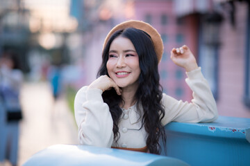 Portrait of a cute and bright Asian woman in her own lifestyle in a theme park.