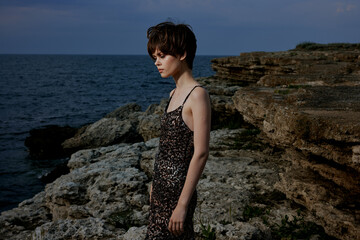 beautiful woman in dress on nature rocks landscape outdoors