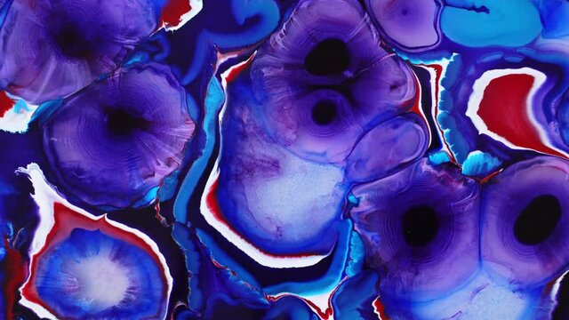 Background made with alcohol ink. Blooming magical Violet flowers. Ink in liquid. Circles of paint radiating over the surface. Deep ink spaces.