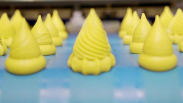 Moving confectionery on a conveyor line close-up.