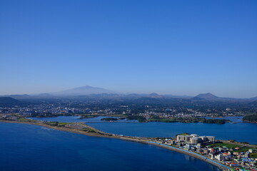 Naklejka premium Blue sea and sky scenery of Seongsan Ilchulbong (UNESCO World Heritage Site) in Jeju Island, South Korea