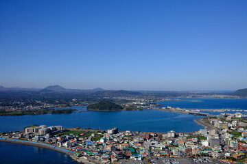 Naklejka na ściany i meble Blue sea and sky scenery of Seongsan Ilchulbong (UNESCO World Heritage Site) in Jeju Island, South Korea