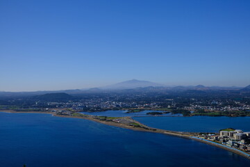 Fototapeta na wymiar Blue sea and sky scenery of Seongsan Ilchulbong (UNESCO World Heritage Site) in Jeju Island, South Korea